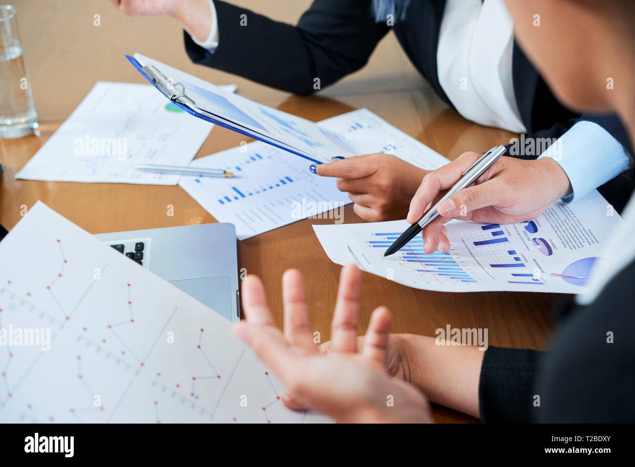 Business discussing financial statistics Stock Photo