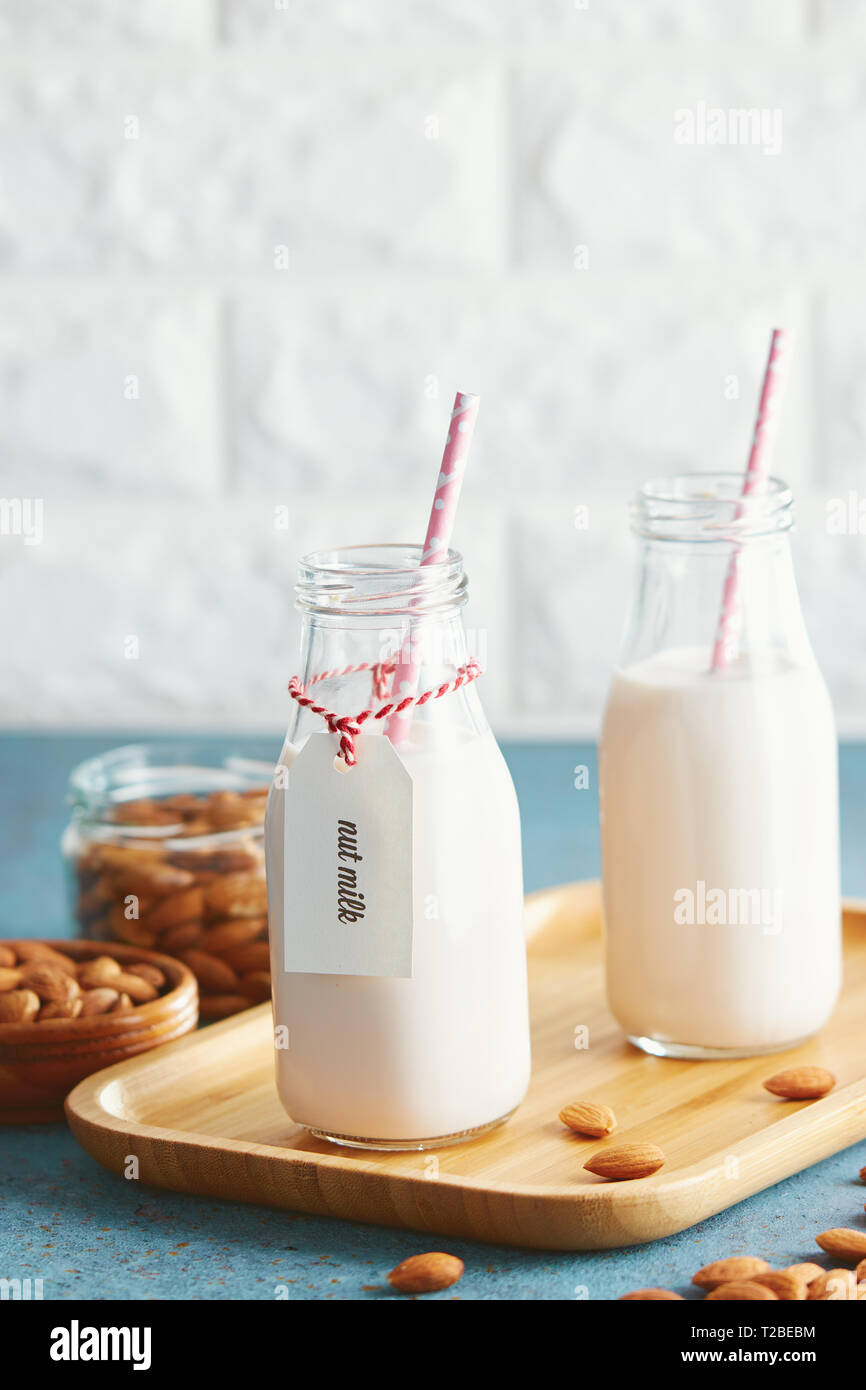 Vegan substitute dairy milk. Glass bottles with nondairy milk and