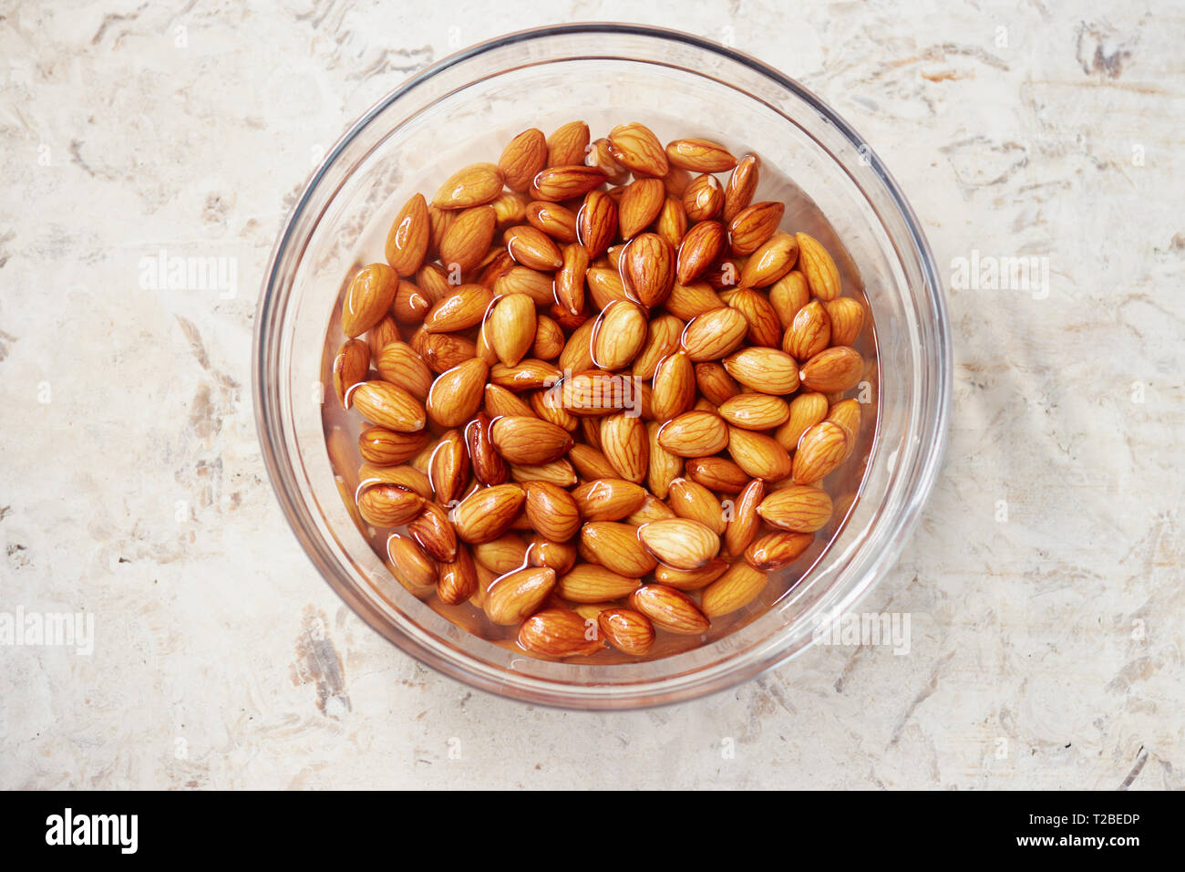 Soaking almonds in water. Almonds being softened in water to create almond milk. Stock Photo