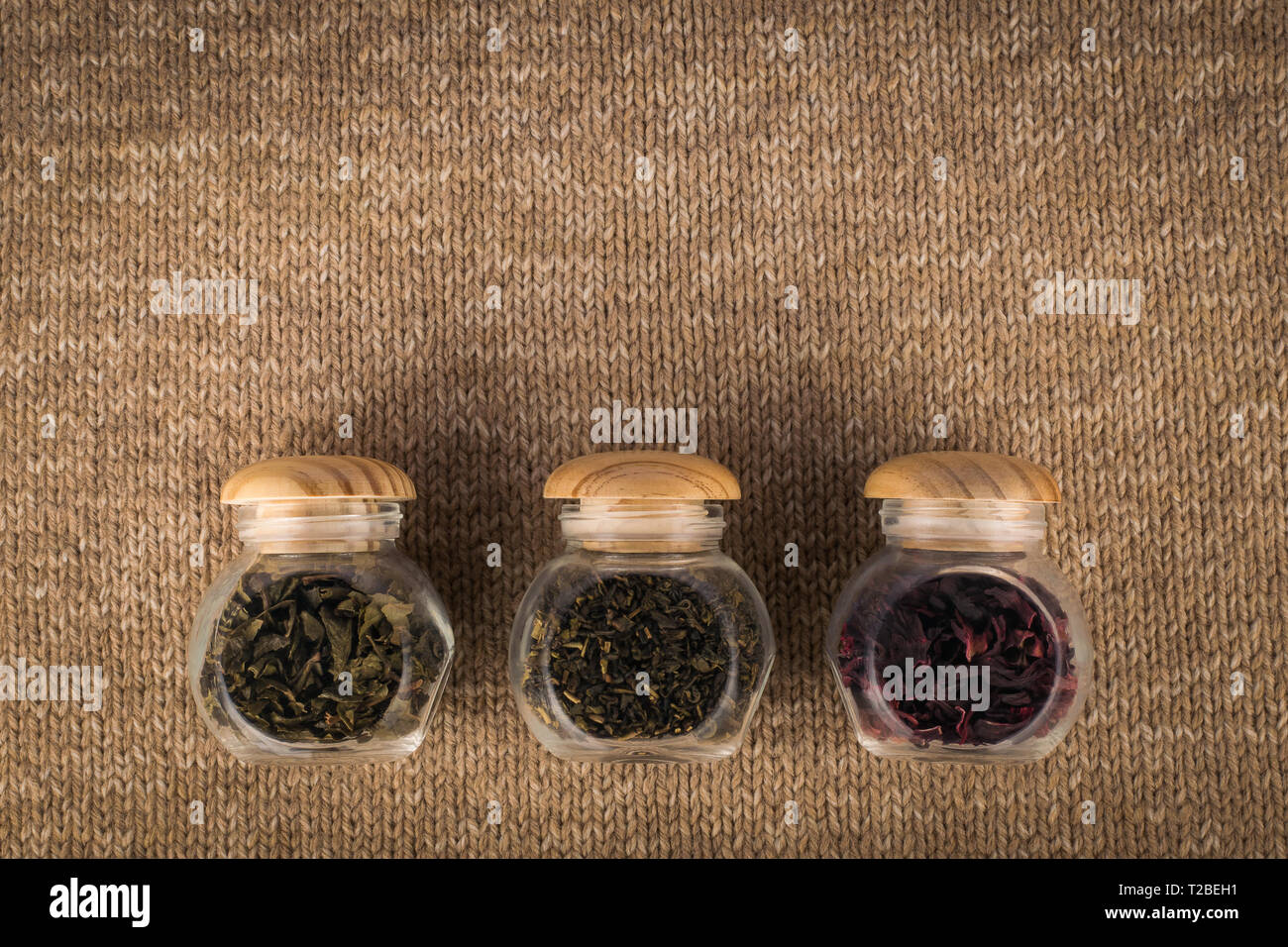 Different kinds of tea in small glass jars Stock Photo