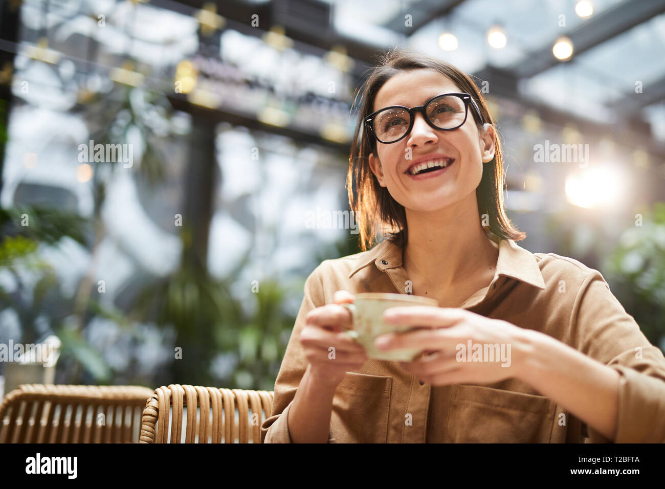 Cheerful lady drinking coffee Stock Photo