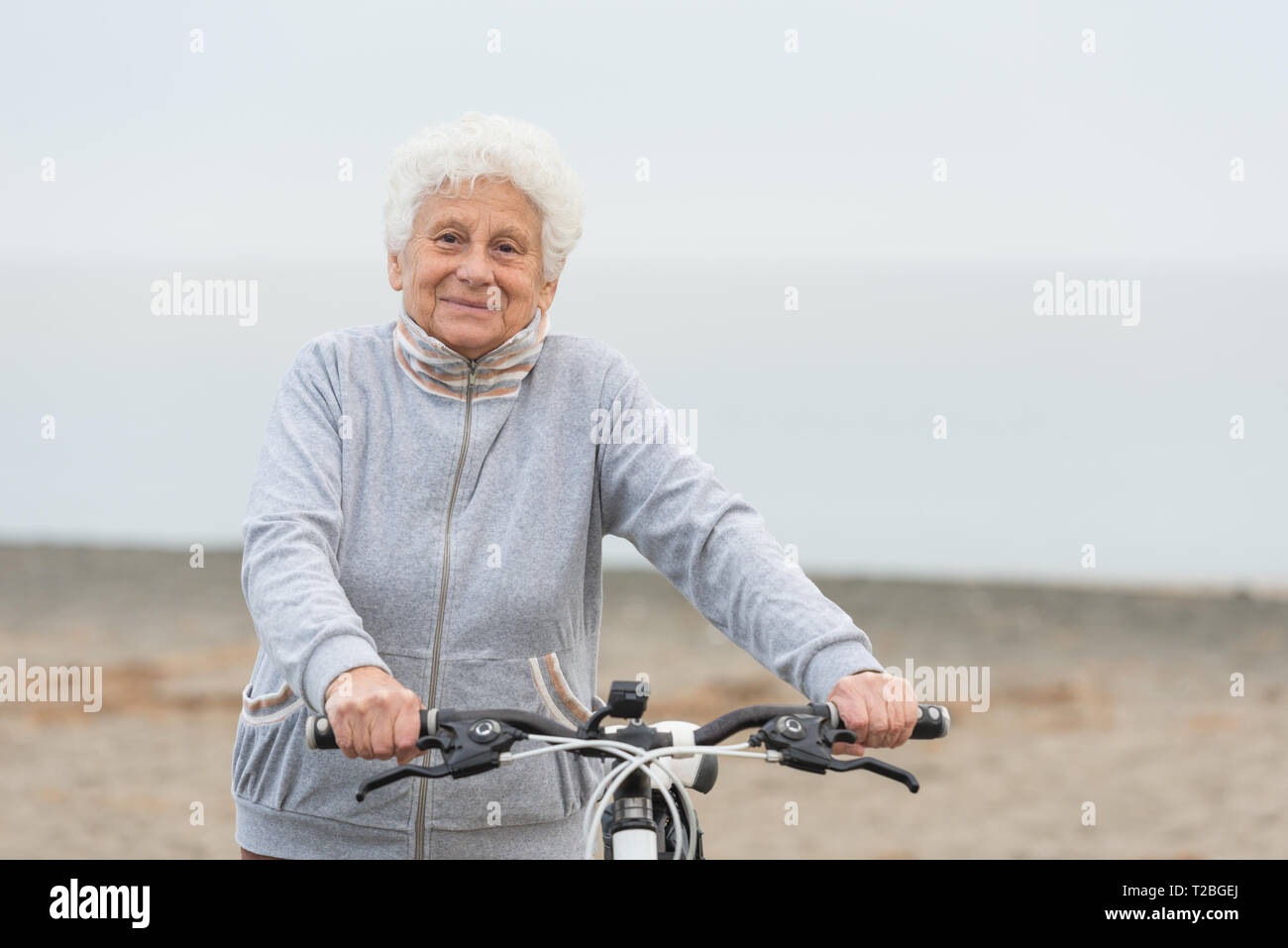 senior woman cycling outdoors Stock Photo