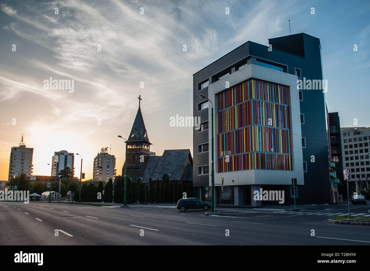 Empty street with colorful building and church at sunset in Brasov, Romania Stock Photo