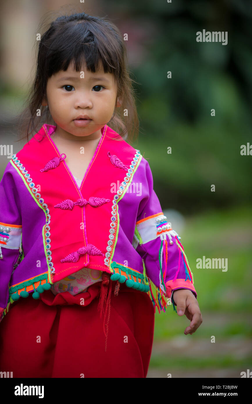 Baan Tong Luang Chiang Mai Thailand April 16 2018 little girl wearing traditional clothes looks towards the camera Stock Photo