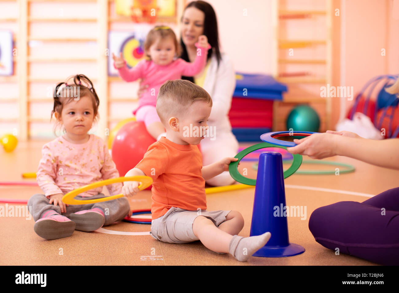 Nursery babies group doing sport in gym Stock Photo Alamy