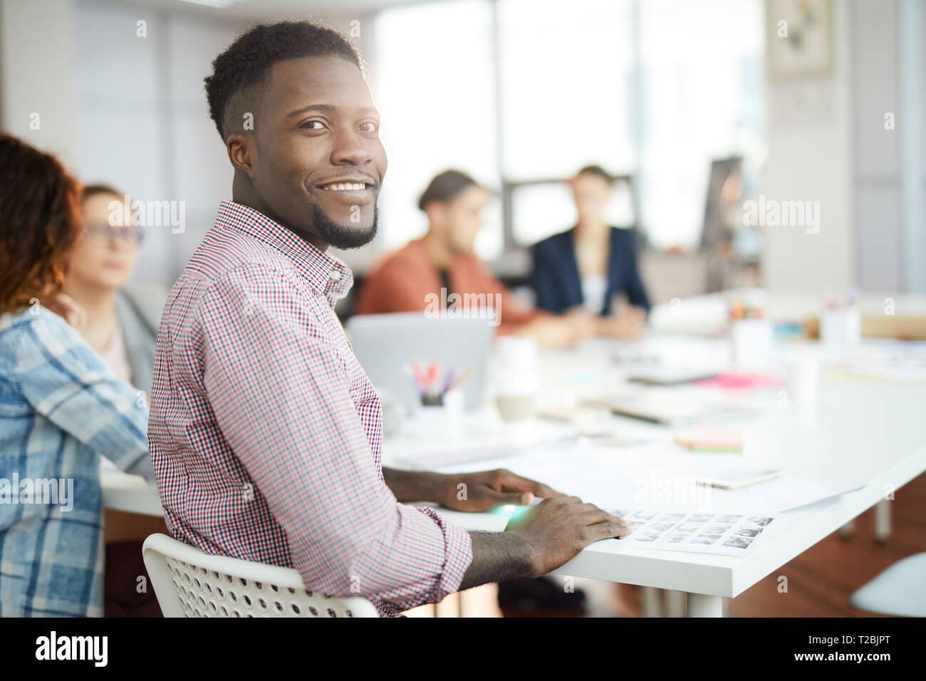 Young African Man Posing in Office Stock Photo
