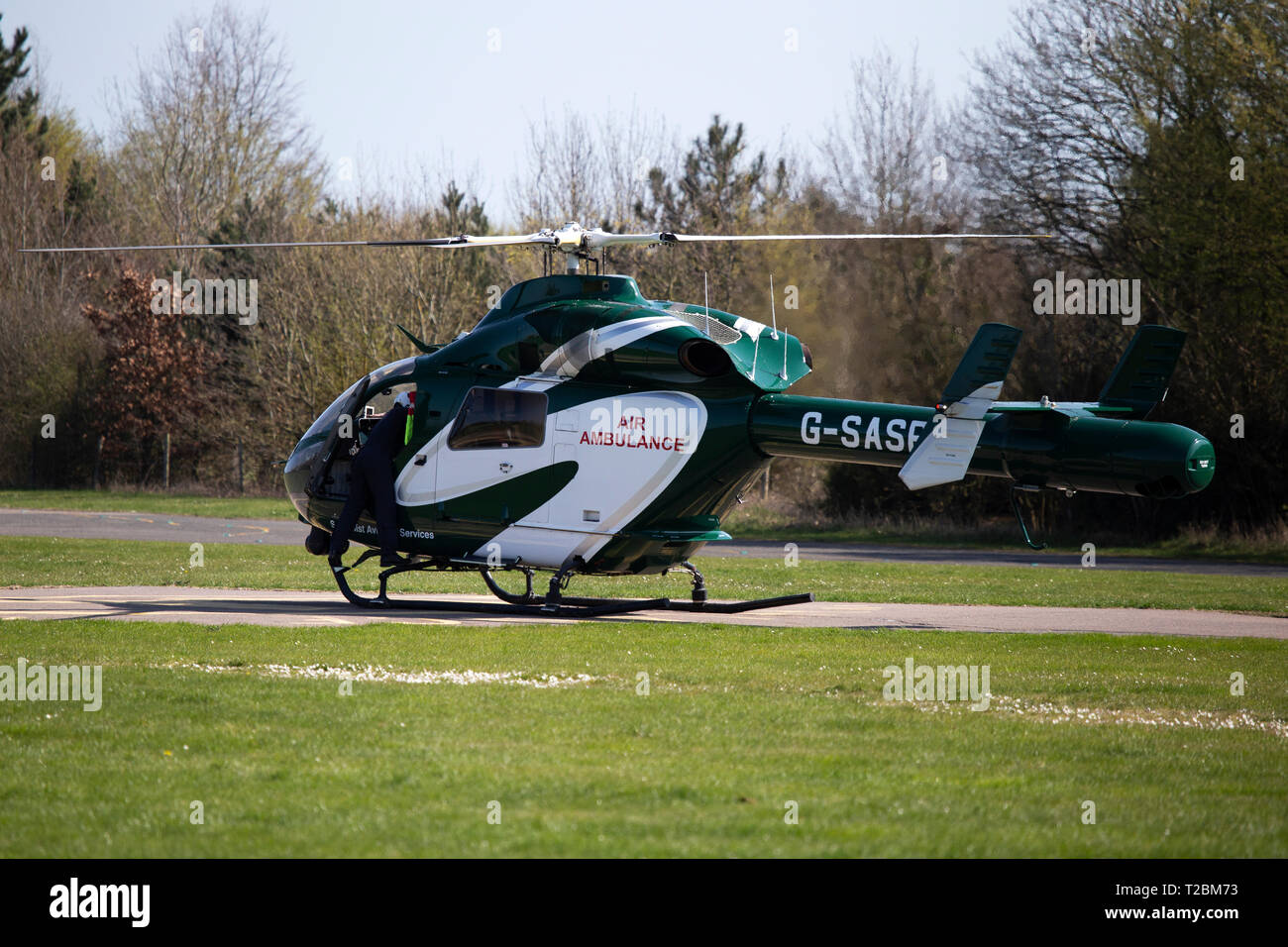 Helicopter Operating for Essex & Herts Air Ambulance Taking off from Earls Colne Aerodrome in Essex on a Fine Spring Day Stock Photo
