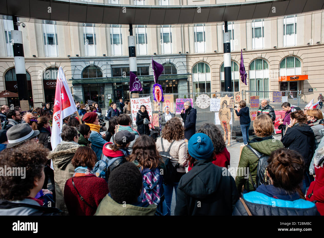 A group of protesters are seen listening the speeches during the Defend abortion right demonstration. At the same time that a March for life was celebrated in Brussels, the Belgian collective organized a 'Defend abortion right' demonstration at the Brussels central station. Since October 2018 in Belgium, abortion is no longer regulated by the penal code but by the civil code. Just before the final vote in September 2018, several thousand people had walked the streets of Brussels to demand real decriminalization of abortion. The organization also asked the people to bring their metal coat hange Stock Photo