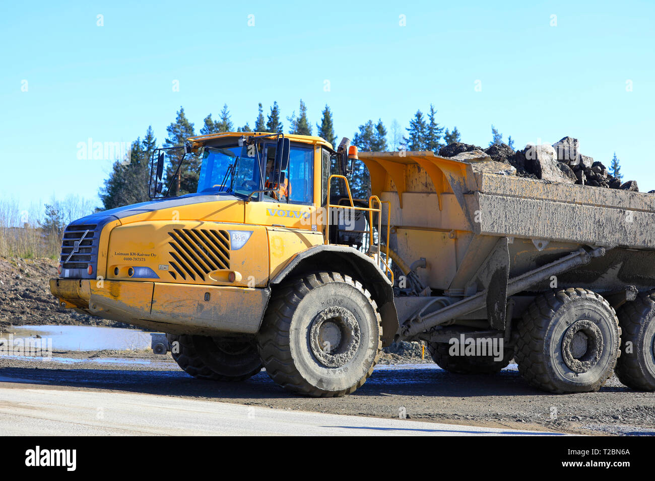 Lieto, Finland - March 22, 2019: Volvo articulated hauler A35D hauls load of stone and gravel at construction site in South of Finland on a day of spr Stock Photo