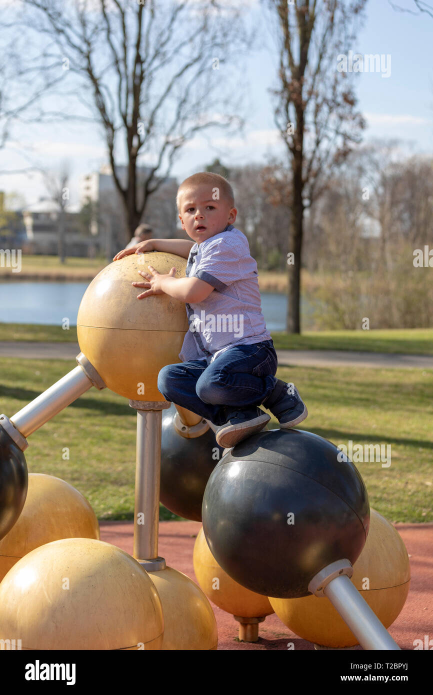 Portrait of a little blond boy on playground. Stock Photo