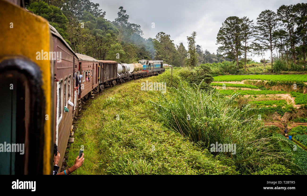 View of train and carriages taking bend on classic Nanu Oya railway trip in Sri Lanka on 24 September 2016 Stock Photo