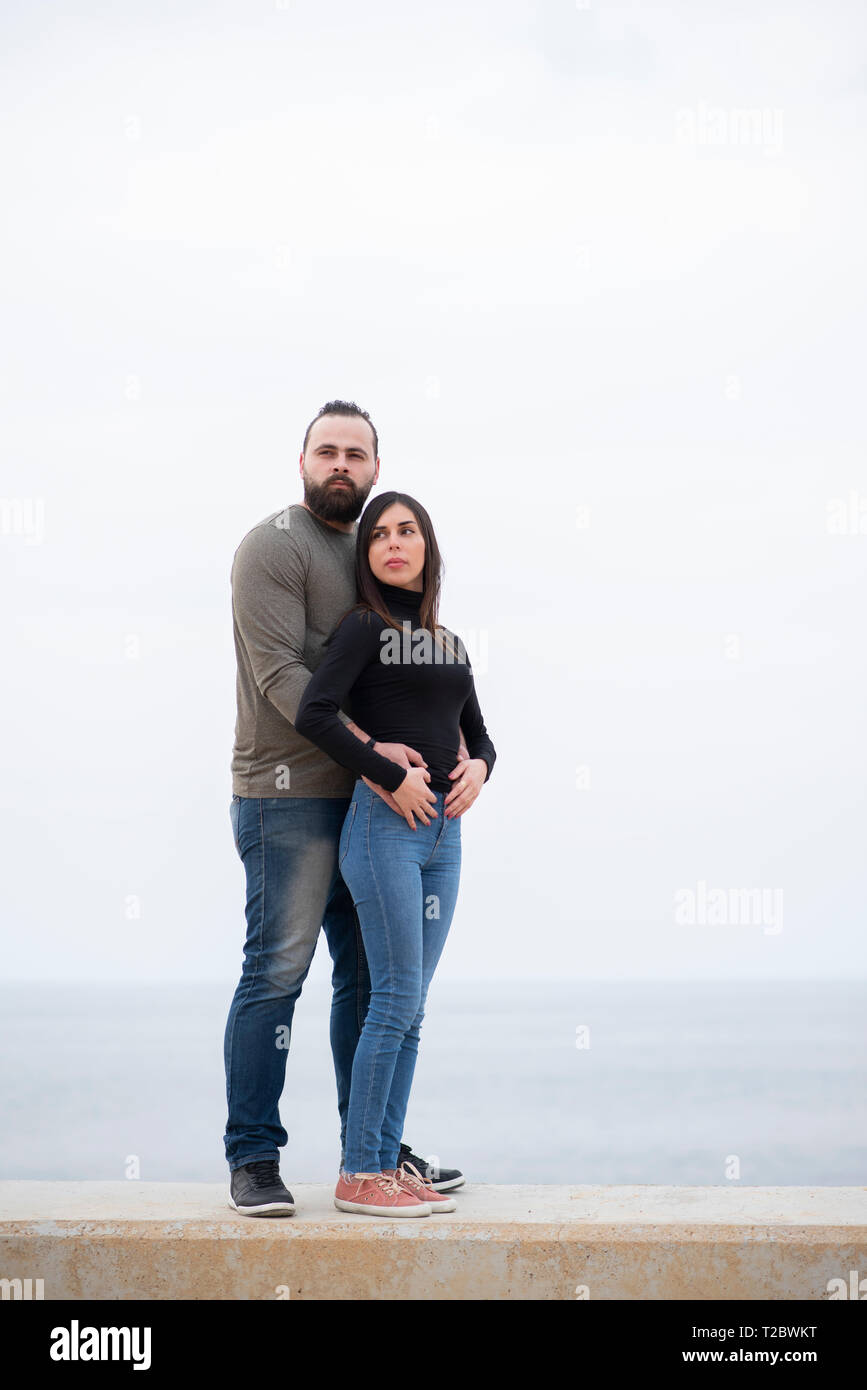 Man and woman standing on the beach Stock Photo