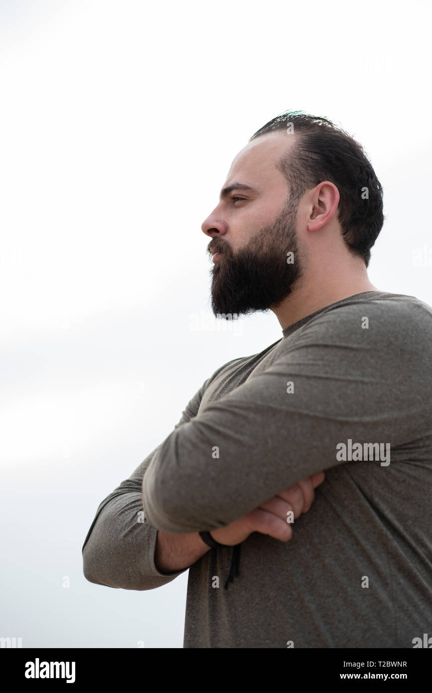 Young man side view crossed arms hi-res stock photography and images ...