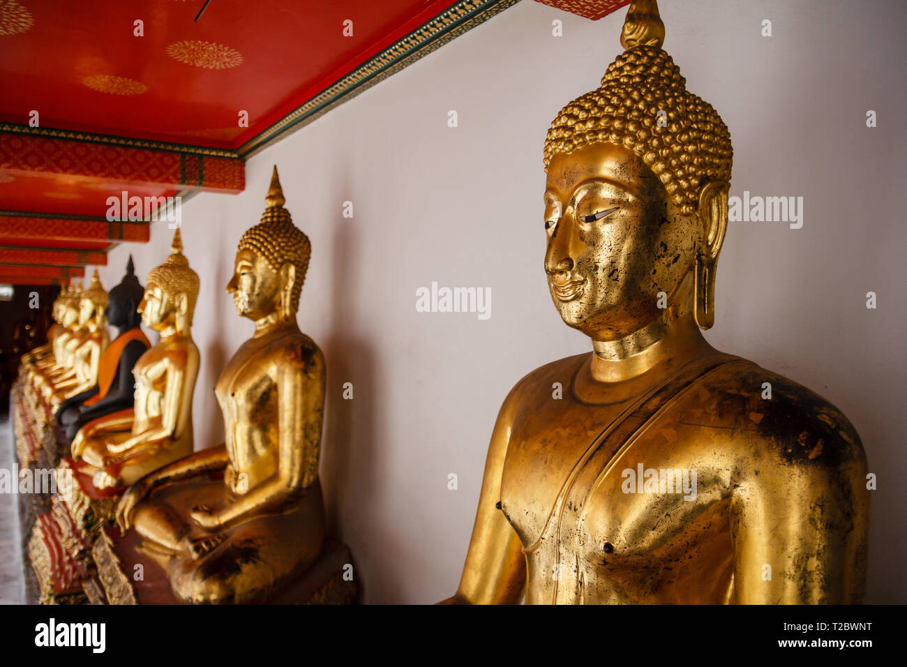 Sitting golden Buddha statues in wat pho temple in Bangkok Stock Photo ...