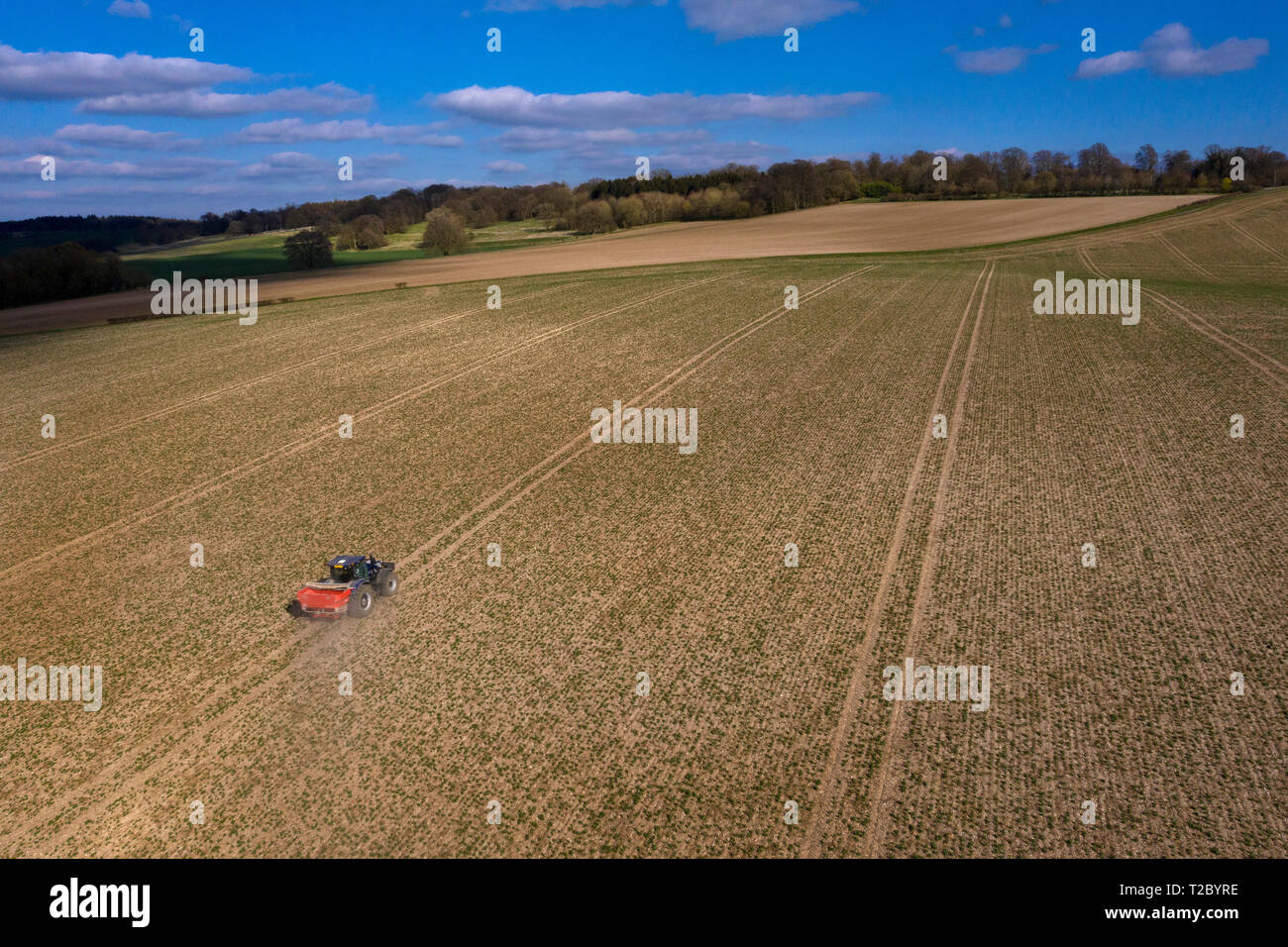 Tractor spreading Fertiliser onto field from above with Drone ,England,UK Stock Photo