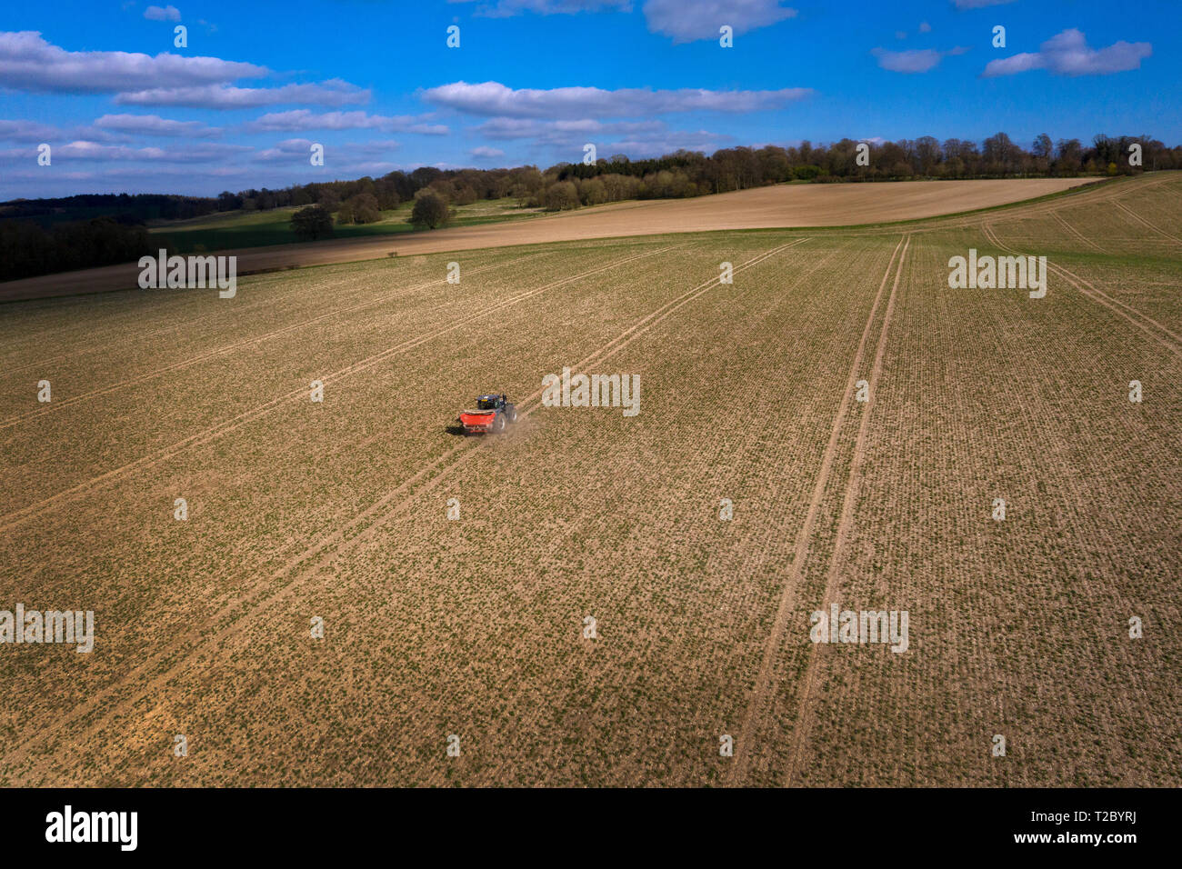 Tractor spreading Fertiliser onto field from above with Drone ,England,UK Stock Photo