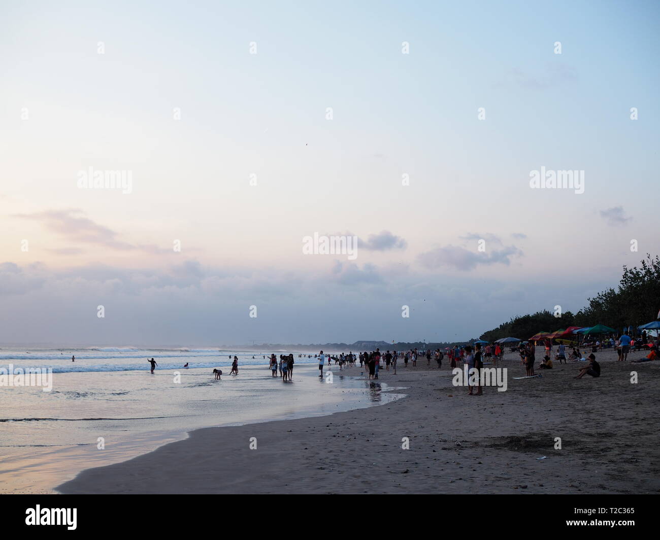 Surfing and sunset on Kuta Beach, Bali, Indonesia Stock Photo