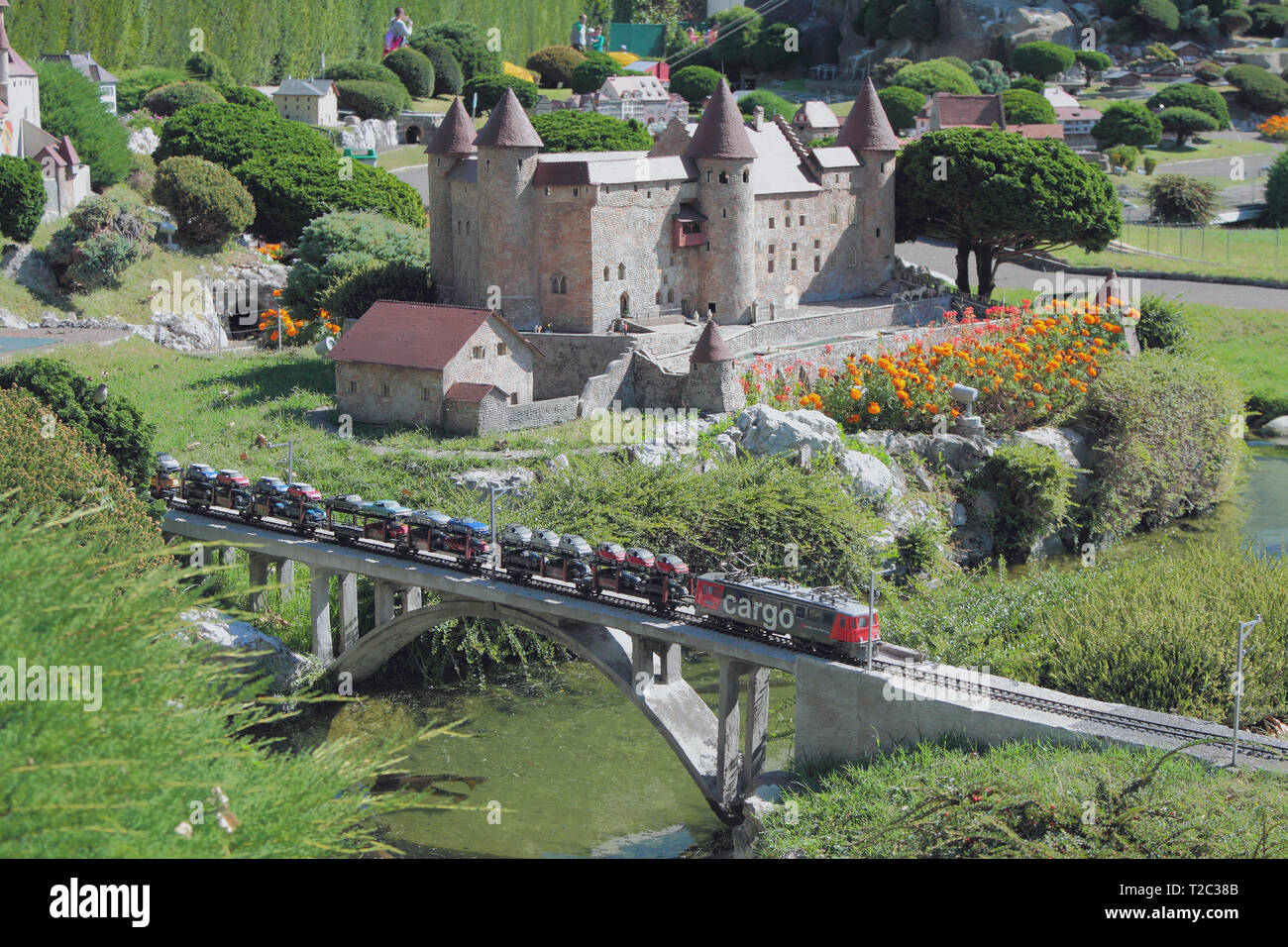 Melide, Switzerland - Sep 27, 2018: River, railway bridge and castle in park of miniatures Stock Photo