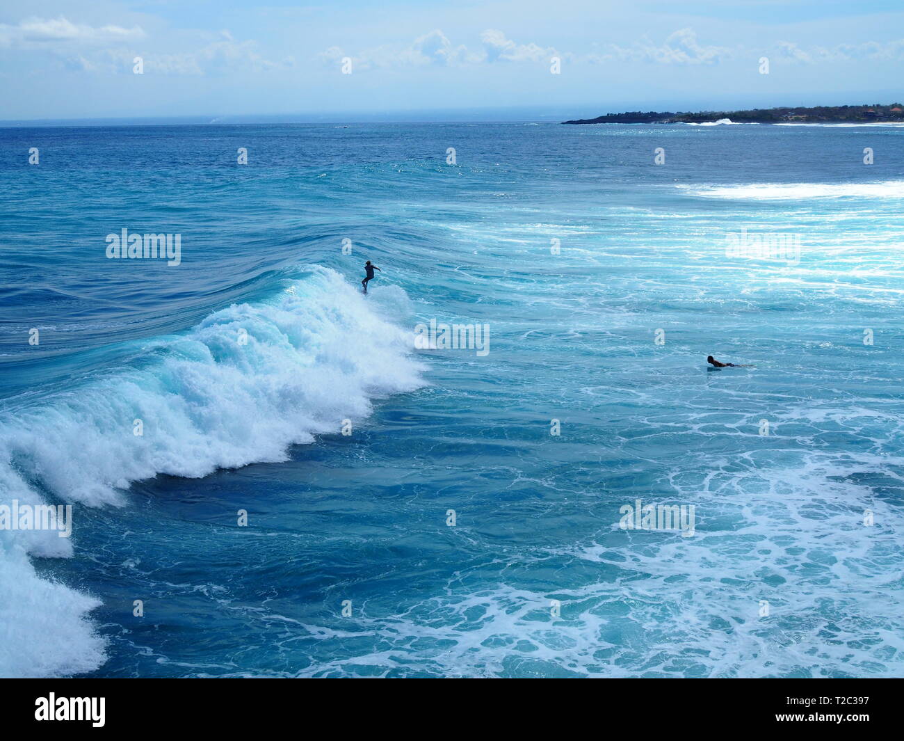 Surfing at Mahana Point, Ceningan Island, Nusa Penida, Indonesia Stock  Photo - Alamy