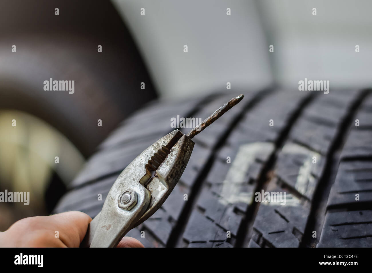 Close up tack in tire ,Flat tire The tire is leaking from the nail .a