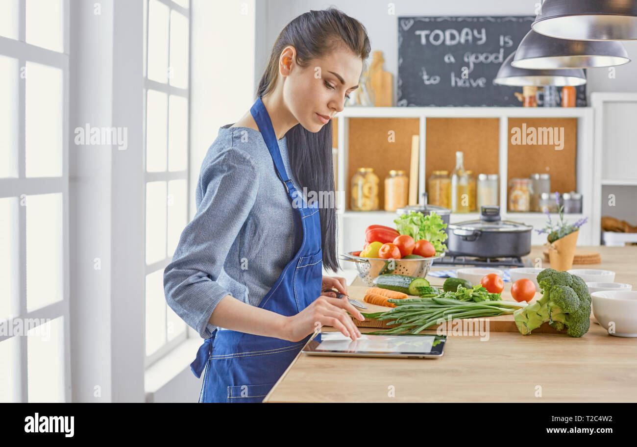 https://c8.alamy.com/comp/T2C4W2/a-young-woman-prepares-food-in-the-kitchen-healthy-food-vegetable-salad-diet-the-concept-of-diet-healthy-lifestyle-cook-at-home-cook-T2C4W2.jpg