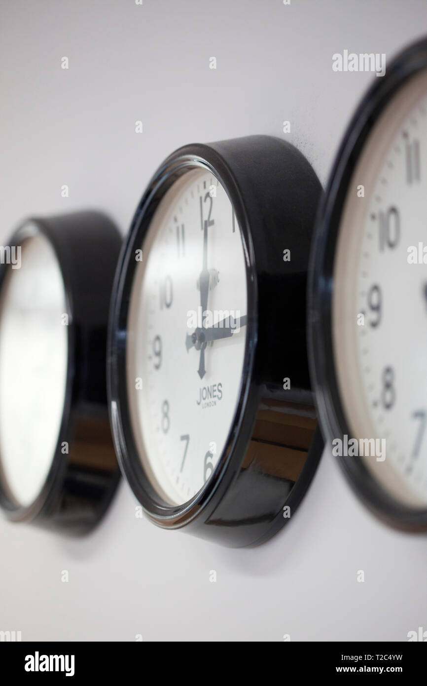 Three clocks on office wall Stock Photo Alamy