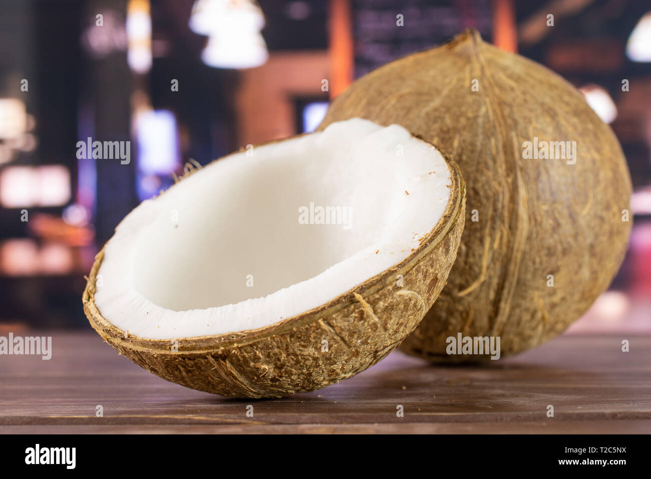 Group of one whole one half of fresh bio coconut in a restaurant Stock