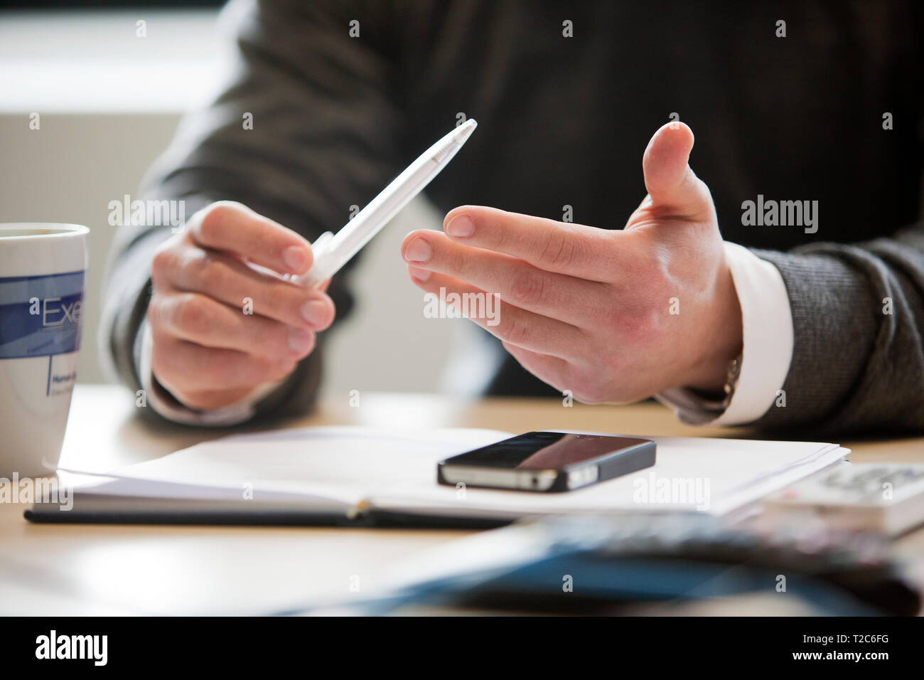 Hands of office worker engaged in discussion Stock Photo