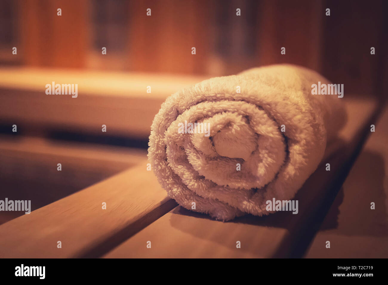 A close up of a soft terry bath towel in a wooden steam sauna. Comfortable rest in a traditional Russian cedar bath. Execellent conviniences for relax Stock Photo