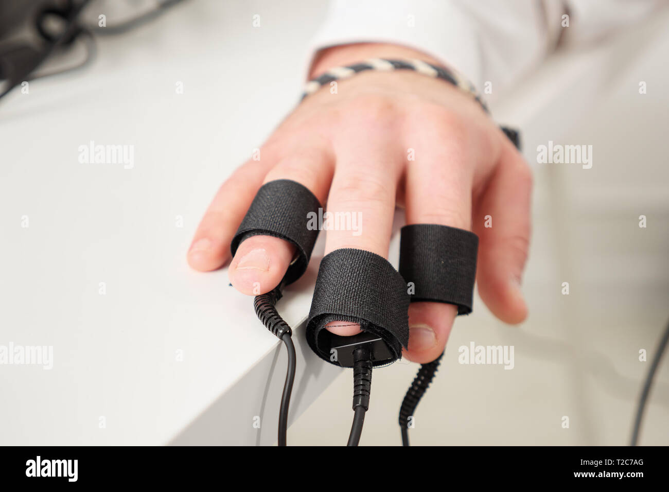 man's hands on which polygraph sensors are worn. Stock Photo