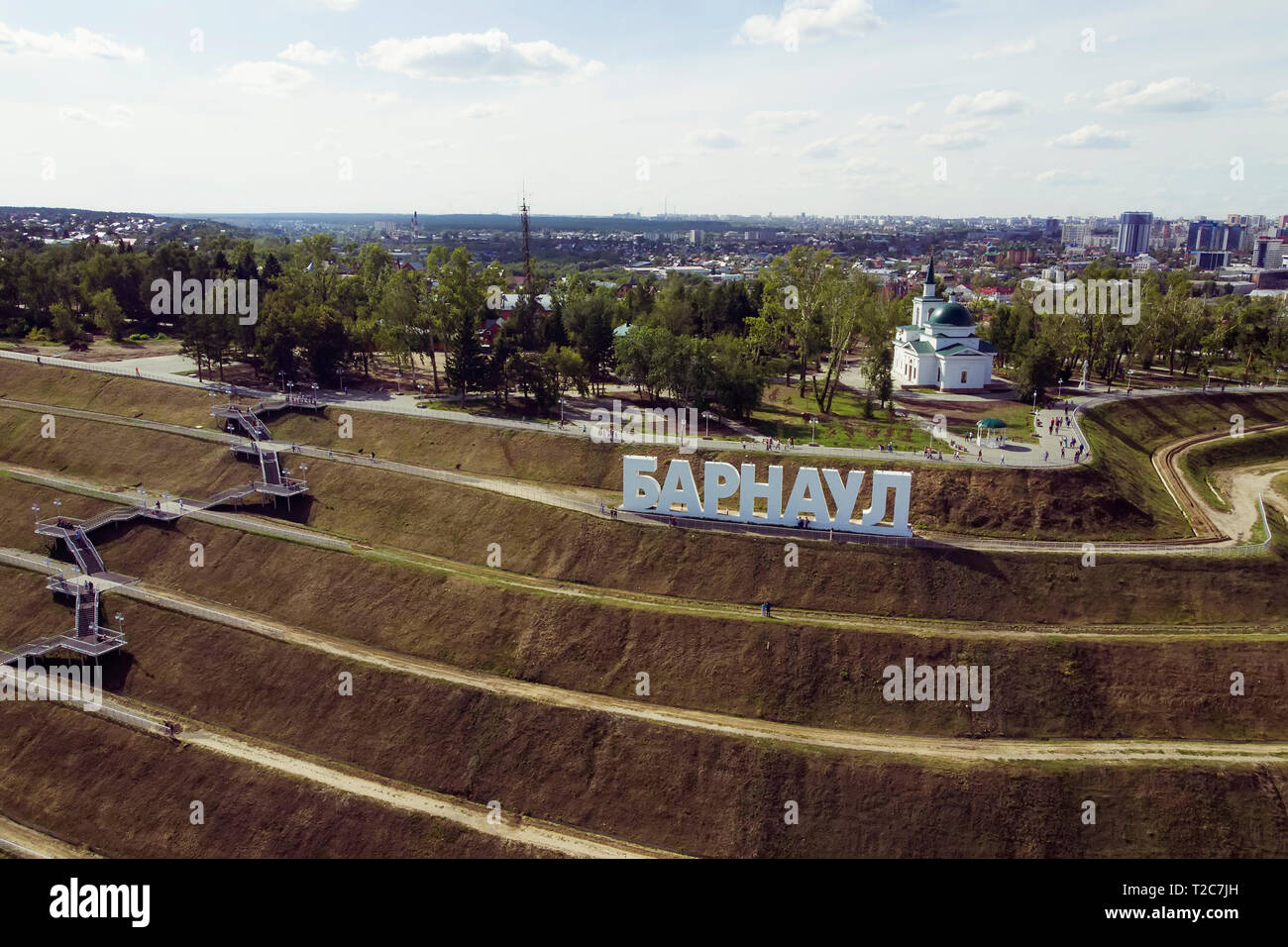 A picturesque bird's eye view to letters on the slope spelling out a Russian city's name BARNAUL. panoramic view to stepped-made hill with big letters Stock Photo