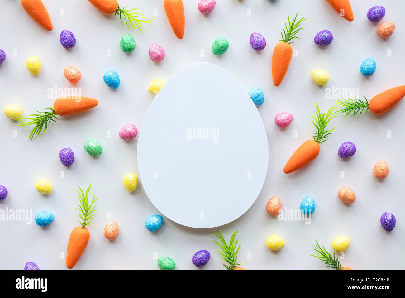 Easter seasonal background with colourful eggs and carrots Stock Photo