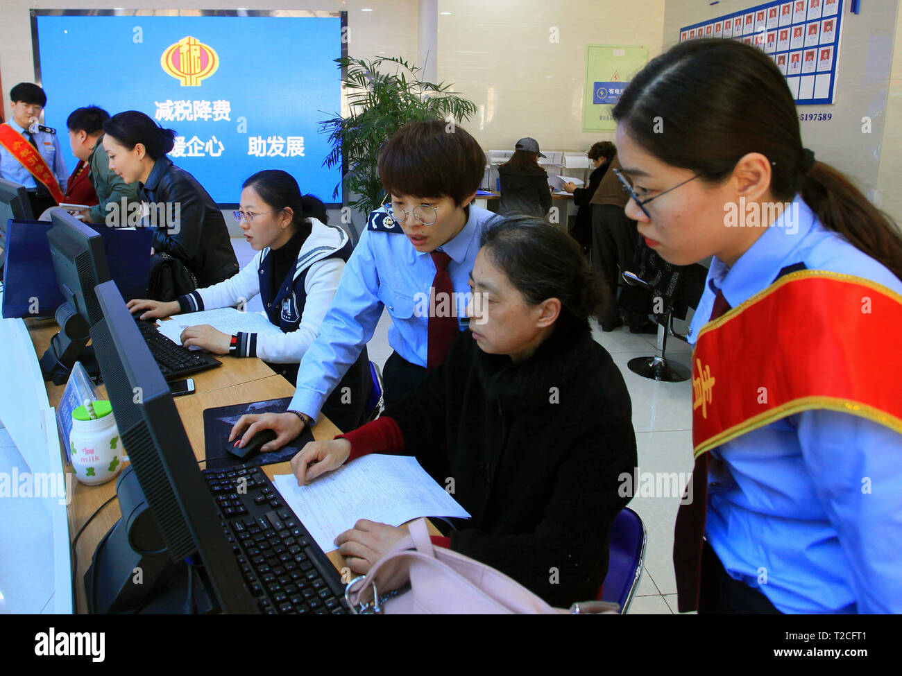 Weihai, China's Shandong Province. 1st Apr, 2019. Staff members help citizens with taxpaying at a local administrative service center in Huancui District of Weihai, east China's Shandong Province, April 1, 2019. Starting on April 1, companies that are subject to the 16-percent VAT rate on their taxable sales or imported goods will enjoy a 13-percent VAT rate, while those who are subject to the 10-percent VAT rate will only need to pay 9 percent, reads a Ministry of Finance statement. Credit: Zhu Chunxiao/Xinhua/Alamy Live News Stock Photo