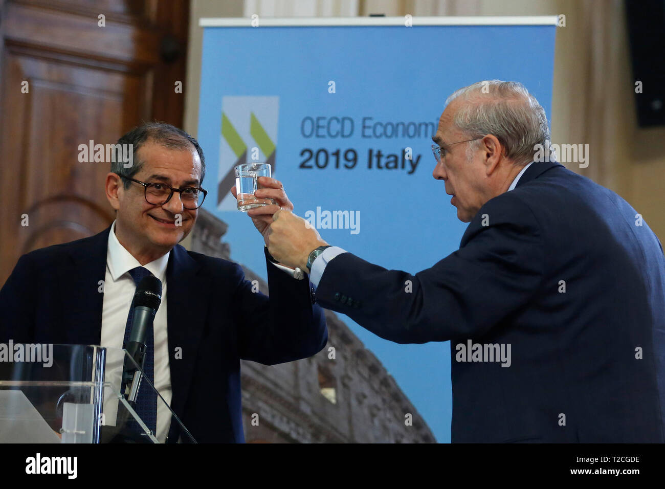 Rome, Italy. 01st Apr, 2019. Secretary General of OECD Angel Gurria handing a glass of water to the Italian Minister of Economy Giovanni Tria Rome April 1st 2019. Presentation of the OECD Report on Italy 2019. The report says after a modest recovery, the Italian economy is weakening. photo di Samantha Zucchi/Insidefoto Credit: insidefoto srl/Alamy Live News Stock Photo