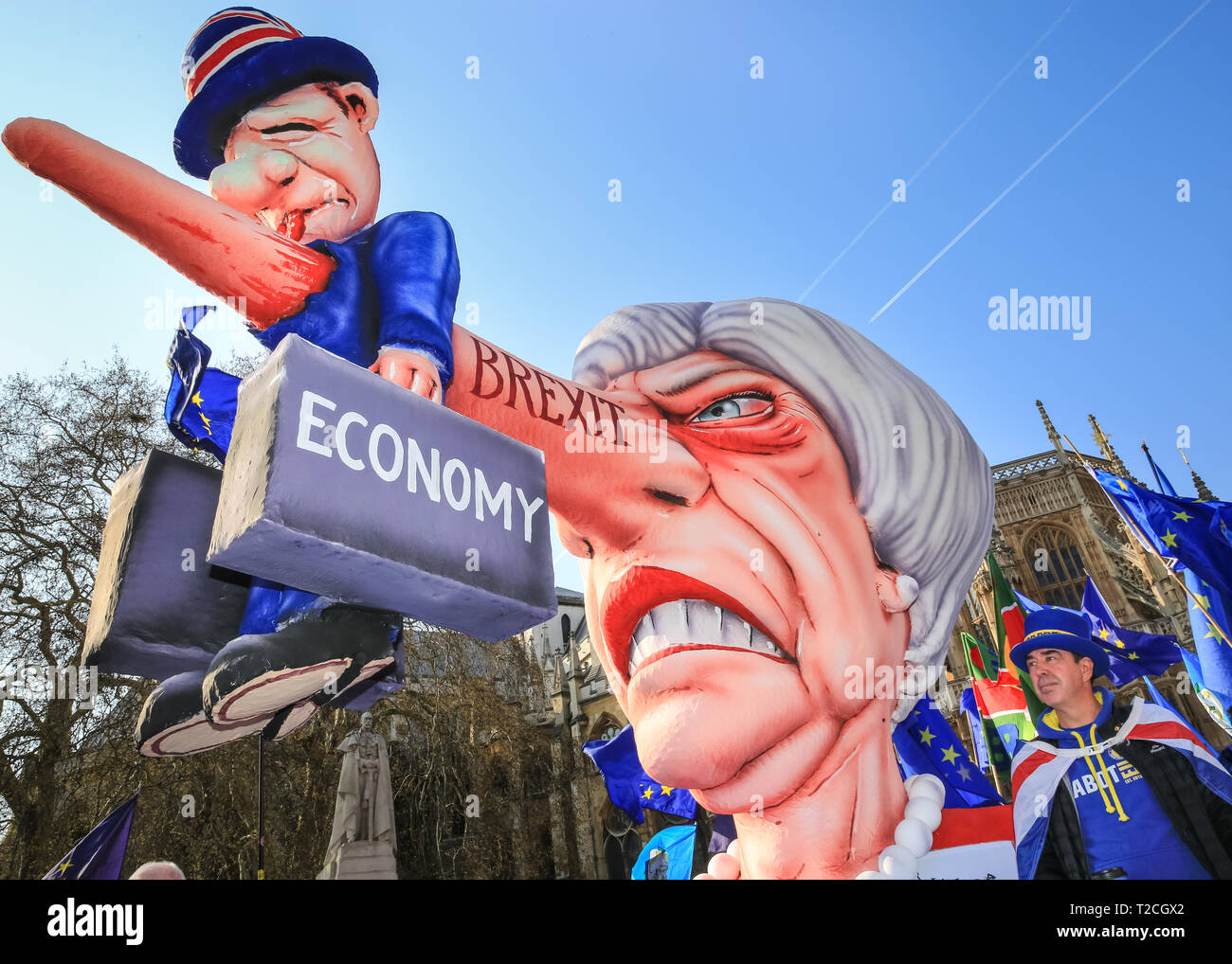 Westminster, London, UK, 1st April 2019. Steven Bray, 'Mr Shouty Man' of Sodem, with the effigy. A giant effigy of Prime Minister Theresa May, with the British economy stuck to her long nose, is seen outside the Houses of Parliament, as Anti-Brexit protesters once again rally in Westminster on another day of voting on amendments in Parliament. The effigy, originally created for Duesseldorf carnival in Germany, first made the journey across the channel for the 'People's Vote' march two weeks ago. Credit: Imageplotter/Alamy Live News Stock Photo