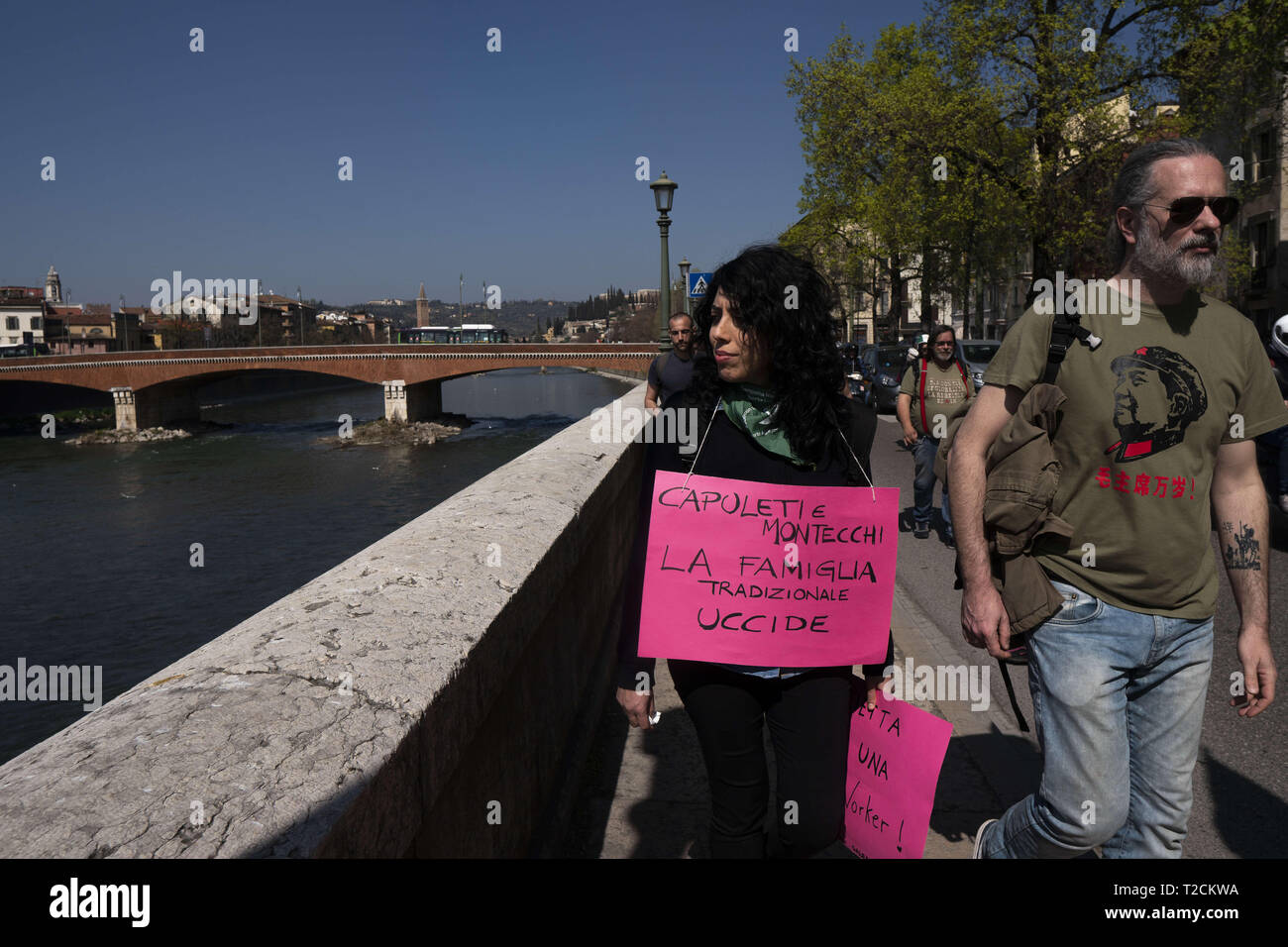 Verona, Veneto, Italy. 30th Mar, 2019. A woman seen moving with placards.The Italian Women organization Non Una di Meno called for a march against the thirteenth 'World Congress of Families'' (WCF) in Verona. The WCF gathers several representatives of 'pro-life movements'' in Europe and abroad, personalities from the religious world against abortion and it's reportedly connected to far-rights movements. Non Una di Meno and other associations protest against the WCF's positions against abortion, homosexuality and their aims to write a global agenda and politics on these matters. ( Stock Photo