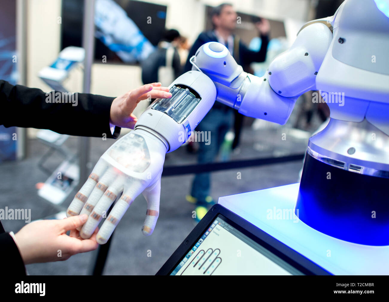 Germany. 01st Apr, 2019. A woman holding the hand of a bionic robot at Festo's stand at the Hanover Fair. From to 5 April, everything at Hannover Messe will
