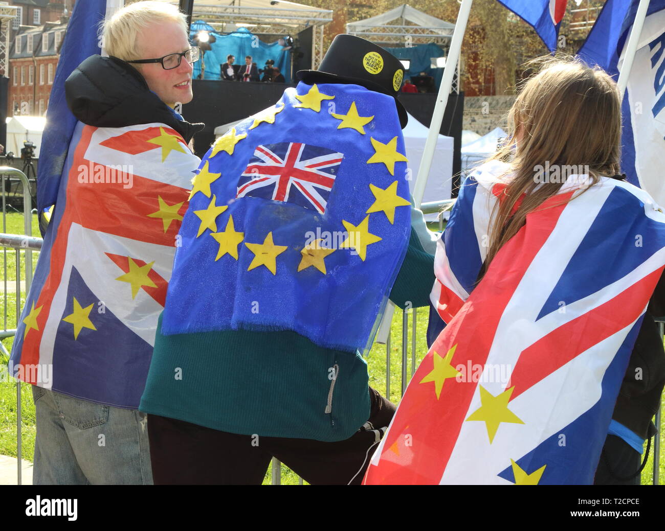Anti Brexit protesters seen wrapped in flags outside Houses of Parliament in Westminster during an anti Brexit demonstration.  MPs debated eight motions related to Brexit and voted later in the evening. Stock Photo