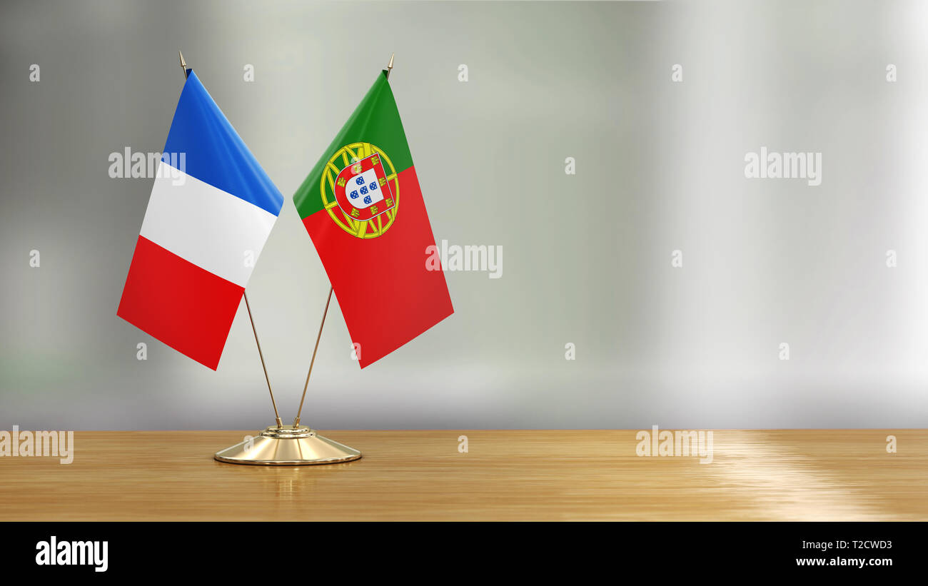 Flags pair on a desk over defocused background Stock Photo
