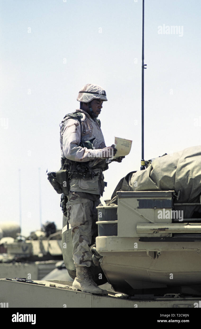 30th October 1993 A black U.S. Army soldier stands on top of his M1A1 Abrams tank of the 24th Infantry Division, 1st Battalion of the 64th Armored Regiment in the new port in Mogadishu, Somalia, having just arrived that morning. Stock Photo