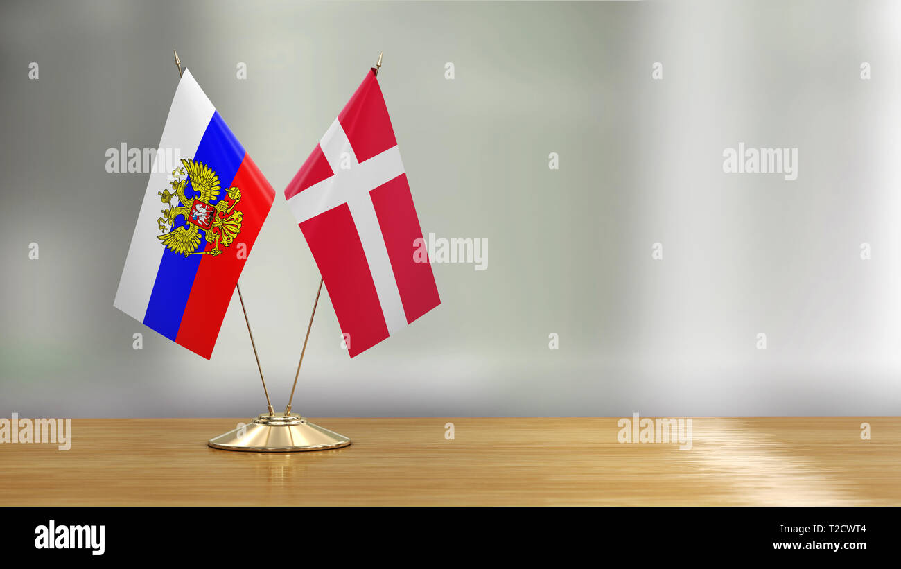 Flags pair on a desk over defocused background Stock Photo