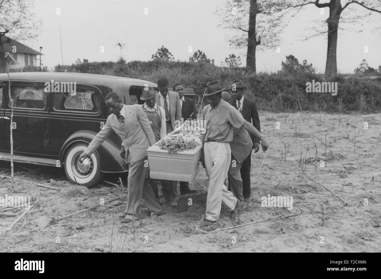 Pallbearers carry the casket of a nineteen year old African-American man who died while working at a saw mill during a funeral in Heard County, Georgia, United States, May, 1941. From the New York Public Library. () Stock Photo