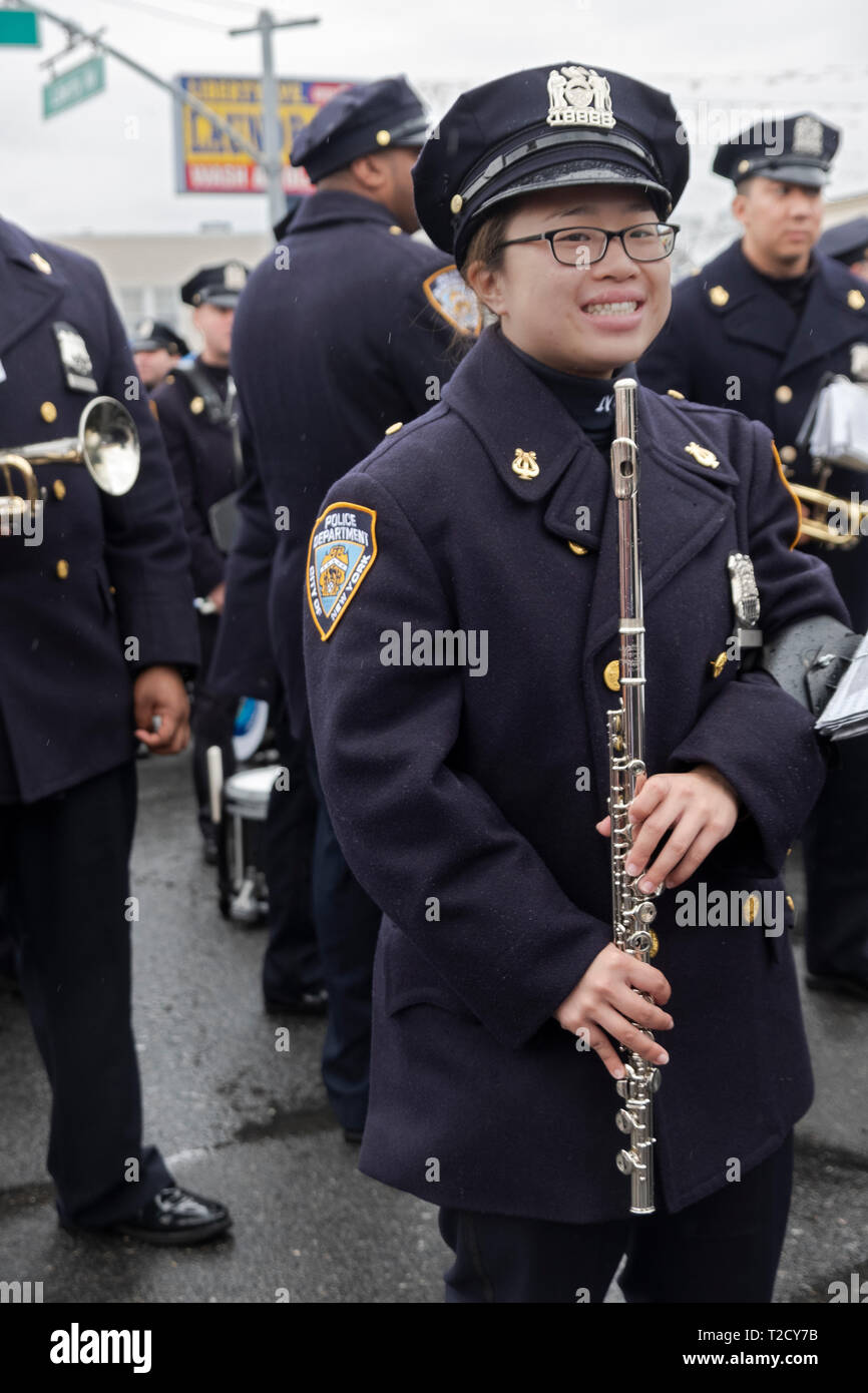 An Asian American member of the NYPD Marching Band poses for a phjoto prior to the Hindu Holi Parade in Richmond Hill, Queens, New York. Stock Photo