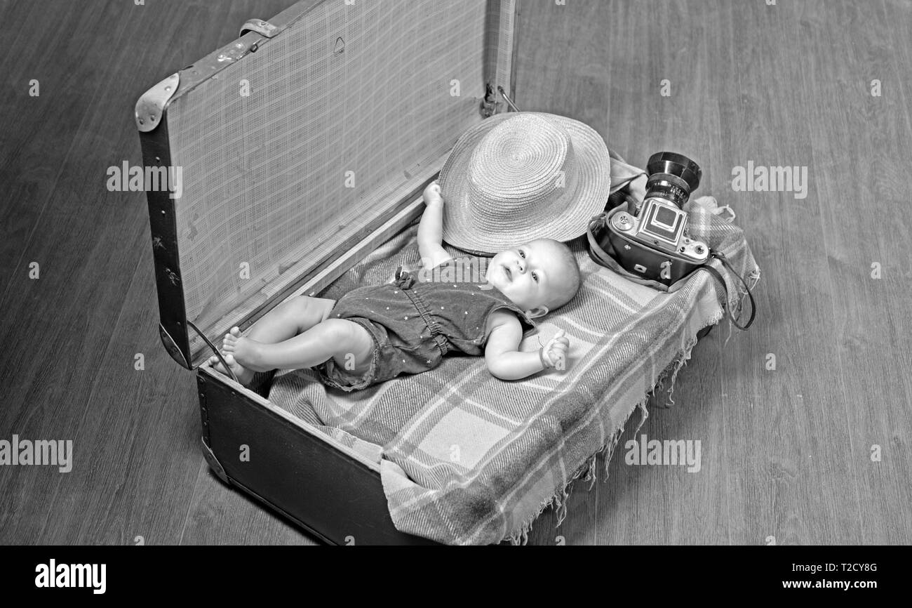 Soon you will be with us. Childhood happiness. Photo journalist. Sweet little baby. New life and birth. Family. Child care. Small girl in suitcase. Tr Stock Photo