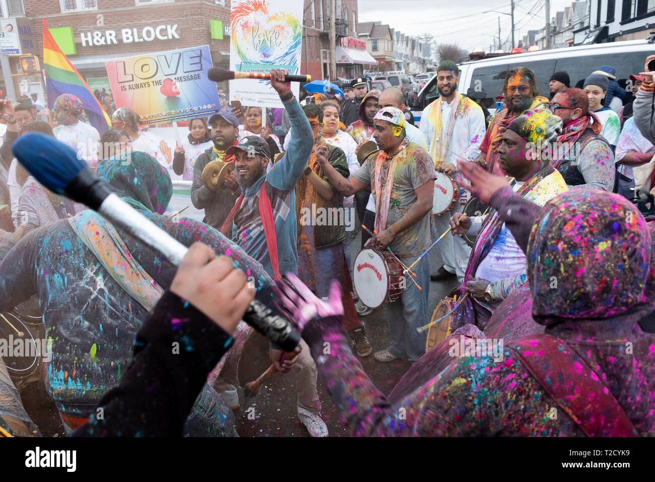 Drummers marching during the at the Holi Parade on Liberty Ave in Richmond Hill, Queens, New York. It's customary to throw & smear colored powder Stock Photo