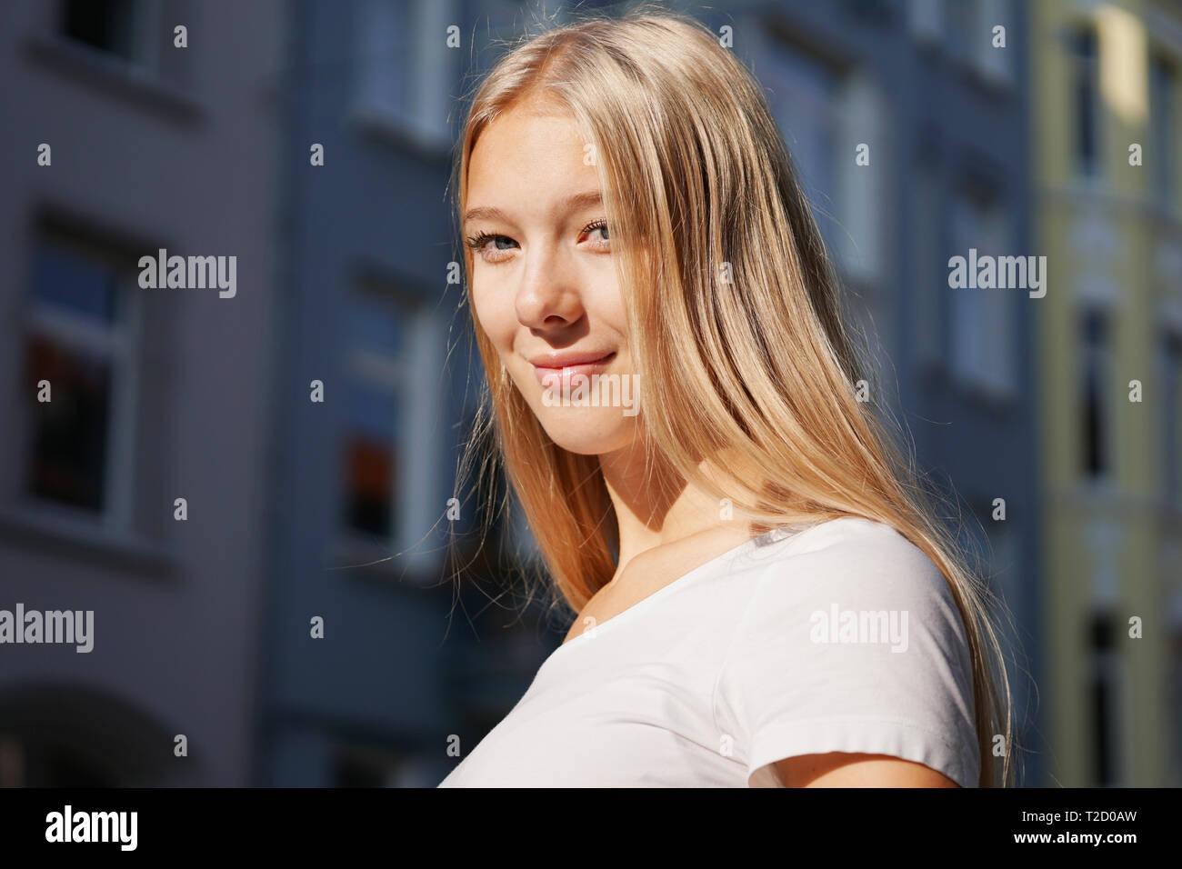candid urban street style portrait of blond young woman Stock Photo