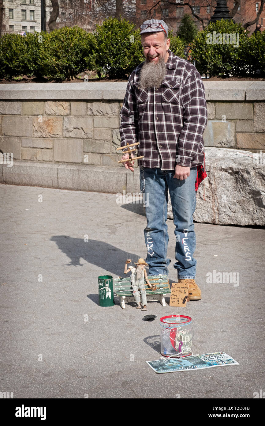 Marionettist Ricky Syers and his marionette Chops Sawyer the drummer performing in Union Square Park in New York City on a warm spring day. Stock Photo