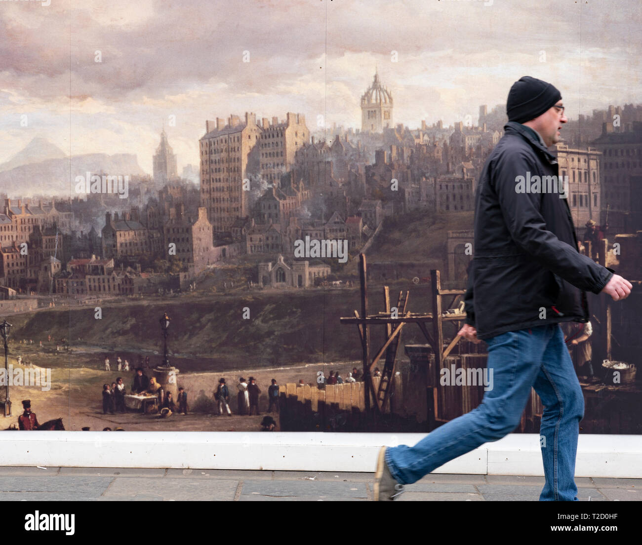 Man walks past billboard at building site of  renovation construction work of Royal Scottish Academy and Scottish National Gallery art museums on The  Stock Photo