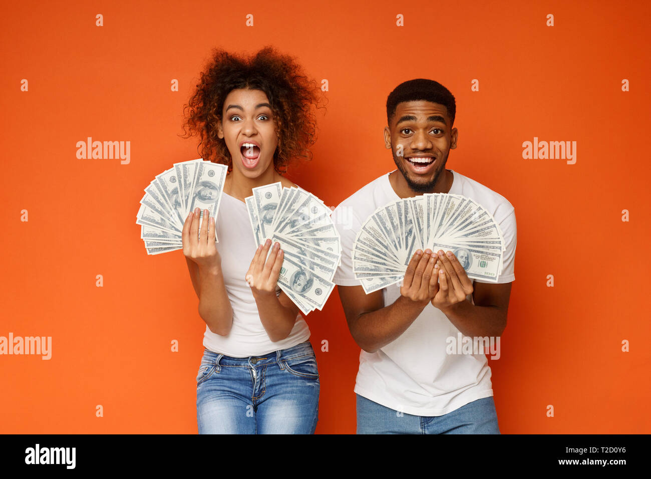 Big Win Shocked And Happy Black Guy And Girl Holding Lots Of