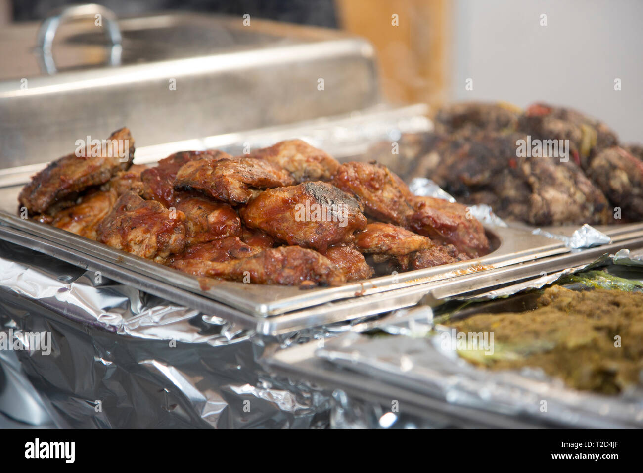 food in heated silver platters at a party, buffet style hot food